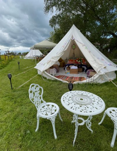A bell tent set up in the orchard